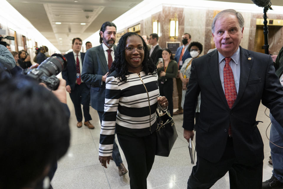 Supreme Court nominee Ketanji Brown Jackson and former Alabama Senator Doug Jones, right, arrive to meet with Sen. Susan Collins, R-Maine, on Capitol Hill in Washington, Tuesday, March 8, 2022. Judge Jackson's confirmation hearing starts March 21. If confirmed, she would be the court's first Black female justice. (AP Photo/Carolyn Kaster)