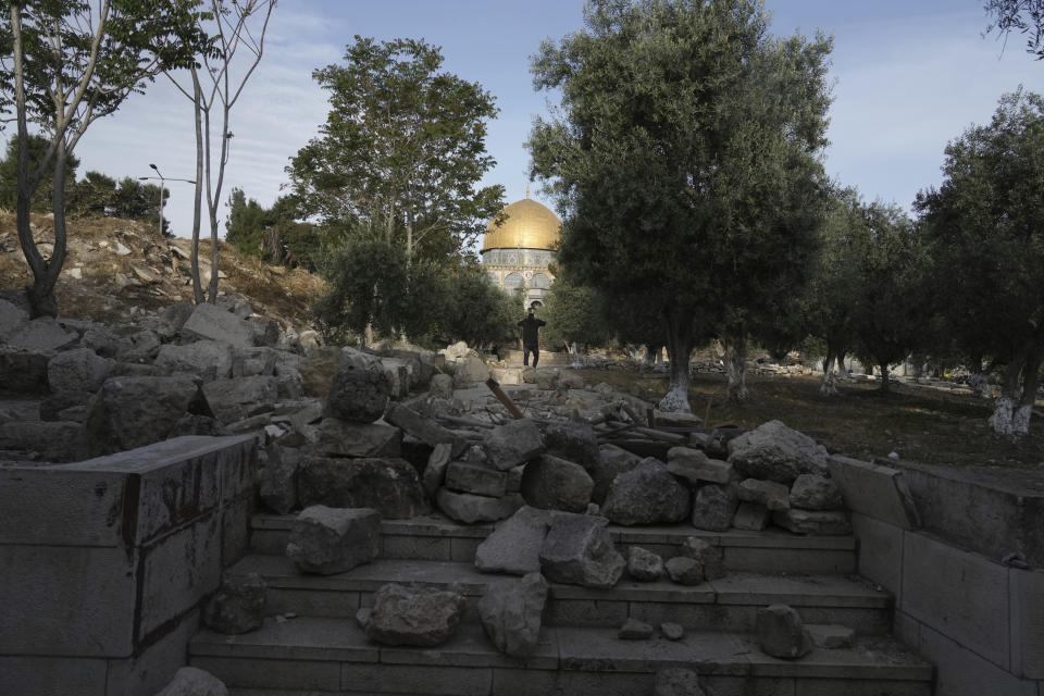 A path at the Al Aqsa Mosque compound is blocked by stones and paving materials amid clashes in Jerusalem's Old City, Friday, April 22, 2022. Israeli police and Palestinian youths clashed again at the major Jerusalem holy site sacred to Jews and Muslims on Friday despite a temporary halt to Jewish visits to the site, which are seen as a provocation by the Palestinians. (AP Photo/Mahmoud Illean)