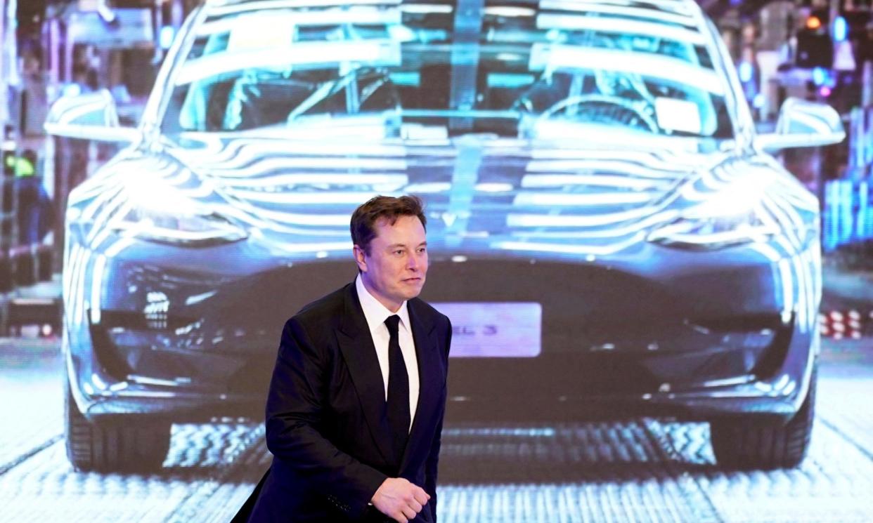 <span>Elon Musk in front of a screen showing a Tesla Model 3 car, in January 2020.</span><span>Photograph: Aly Song/Reuters</span>