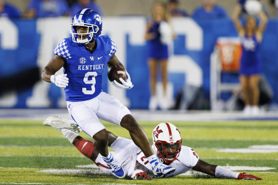 Kentucky wide receiver Tayvion Robinson (9) runs the ball up the field while Miami (Ohio) defensive back Michael Dowell (21) falls short of a tackle during the second half of an NCAA college football game in Lexington, Ky., Saturday, Sept. 3, 2022. (AP Photo/Michael Clubb)