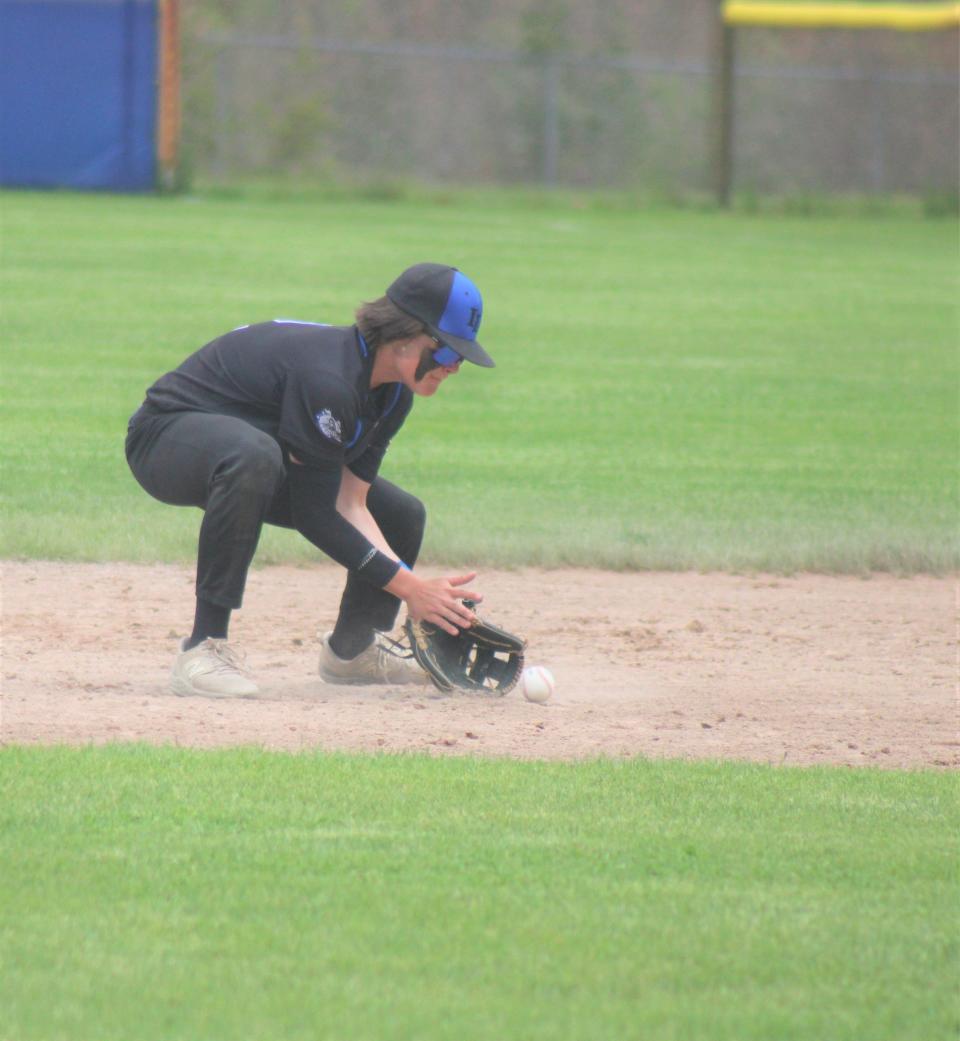 Inland Lakes sophomore second baseman Ty Kolly fields a ground ball during game one against Gaylord St. Mary on Wednesday.