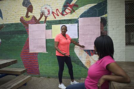 Denise Carey (L), the Committee Person for the 44th ward, 16th division advises a voter before entering a West Philadelphia recreation center during the special primary election in Philadelphia, Pennsylvania on May 19, 2015. REUTERS/Mark Makela