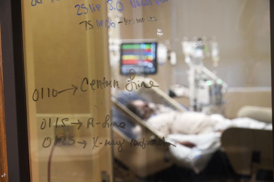 Medical notations are written on a window of a COVID-19 patient's room in an intensive care unit at the Willis-Knighton Medical Center in Shreveport, La., Wednesday, Aug. 18, 2021. The windows were added to the doors to keep the rooms closed for quarantining, which would normally be open in an ICU unit there. (AP Photo/Gerald Herbert)