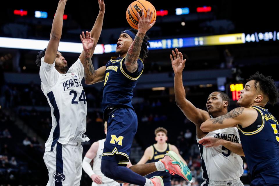 Michigan guard Dug McDaniel (0) goes to the basket against Penn State forward Zach Hicks (24) during the second half of the First Round of Big Ten tournament at Target Center in Minneapolis, Minn. on Wednesday, March 13, 2024.