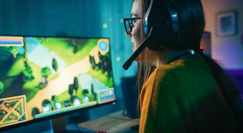 <span class="caption">Cosy gaming is creating a community for gamers outside of traditional stereotypes.</span> <span class="attribution"><a class="link " href="https://www.shutterstock.com/image-photo/excited-concentrated-gamer-girl-glasses-headset-1430159561" rel="nofollow noopener" target="_blank" data-ylk="slk:Shutterstock;elm:context_link;itc:0;sec:content-canvas">Shutterstock</a></span>