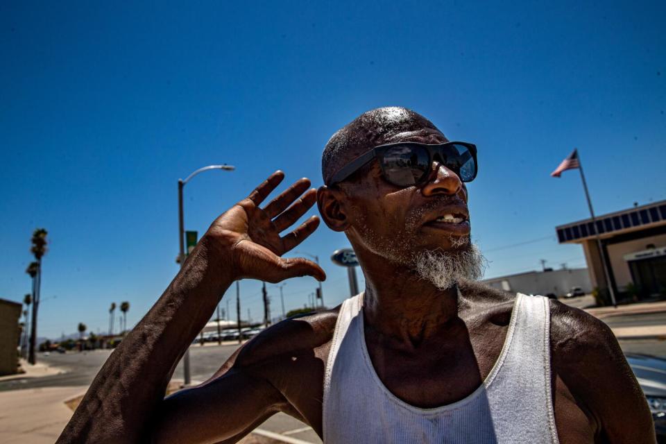 A homeless man in a tank top along Hobson Way in Blythe.