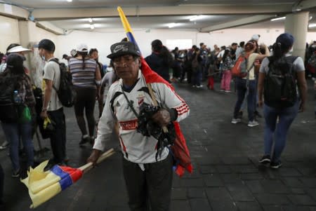 A man carries Ecuadorian flags in the aftermath of the last days' protests, after the government of Ecuadorian President Lenin Moreno agreed to repeal a decree that ended fuel subsidies, in Quito