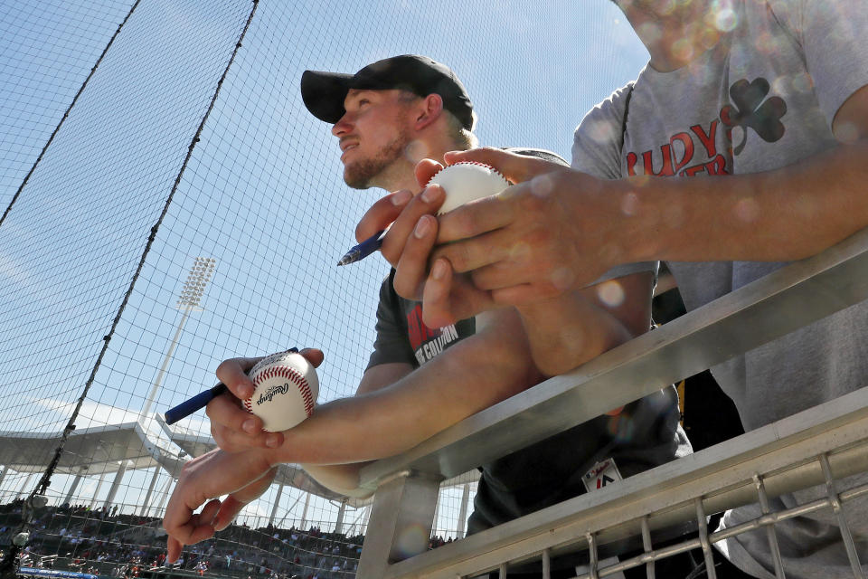 Autograph seekers wait for players before a spring training baseball game between the Boston Red Sox and the Houston Astros, Thursday, March 5, 2020, in Fort Myers, Fla. (AP Photo/Elise Amendola)