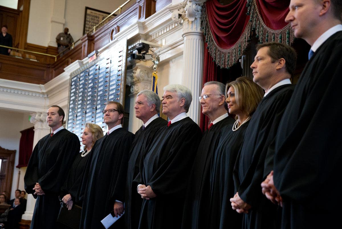 Texas Supreme Court Justice John Devine, far left, with fellow judges on the House floor in Austin in 2013.