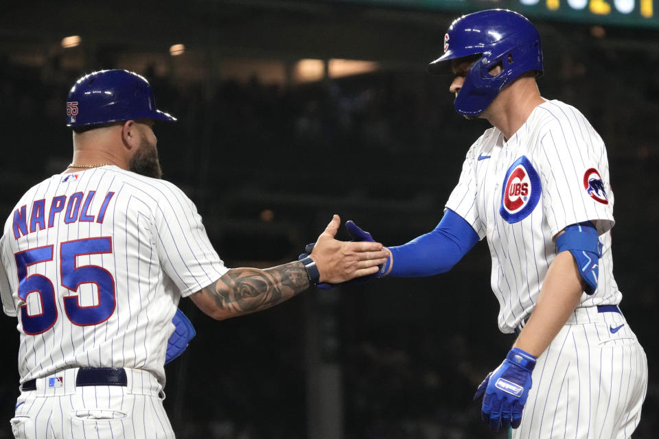 Chicago Cubs' Trey Mancini, right, celebrates with first base coach Mike Napoli after hitting a one-run single during the fifth inning of a baseball game against the Seattle Mariners in Chicago, Tuesday, April 11, 2023. (AP Photo/Nam Y. Huh)