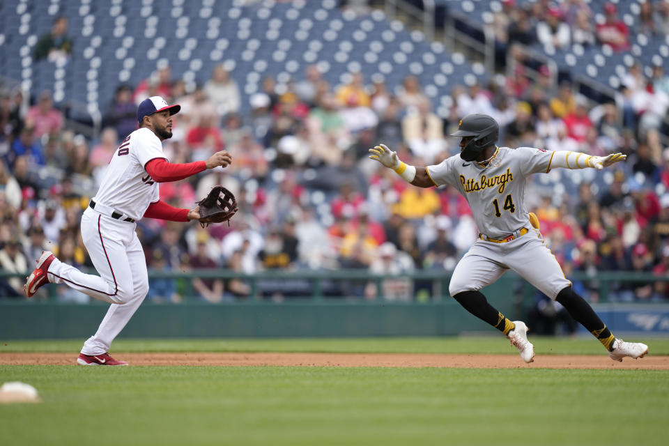 Washington Nationals third baseman Jeimer Candelario, left, catches Pittsburgh Pirates' Rodolfo Castro attempting to steal third base in the second inning of the first baseball game of a doubleheader, Saturday, April 29, 2023, in Washington. (AP Photo/Patrick Semansky)