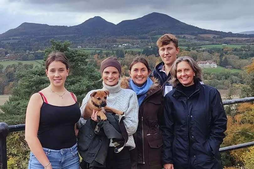 A family on a walk with their dog