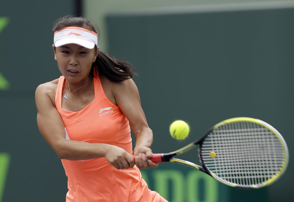 Peng Shuai, of China, returns to Angelique Kerber, of Germany, at the Sony Open tennis tournament in Key Biscayne, Fla., Thursday, March 20, 2014. (AP Photo/Alan Diaz)