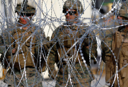 U.S. Marines set up a barricade with concertina wire, at the border between Mexico and the U.S., in preparation for the arrival of migrants, in Tijuana, Mexico, November 13, 2018. REUTERS/Jorge Duenes