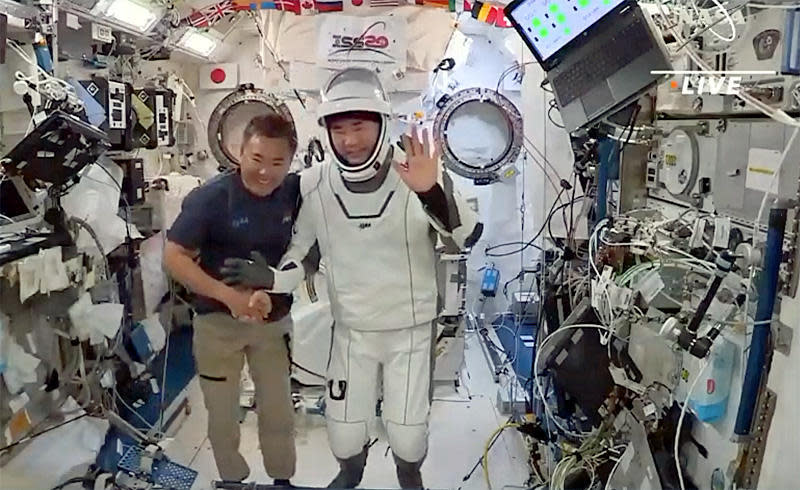 Soichi Noguchi, right, and space station commander Akihiko Hoshide, both astronauts with the Japan Aerospace Exploration Agency, or JAXA, pose in the Japanese Kibo laboratory module moments before Noguchi made his way into a SpaceX Crew Dragon spacecraft for undocking. / Credit: NASA TV