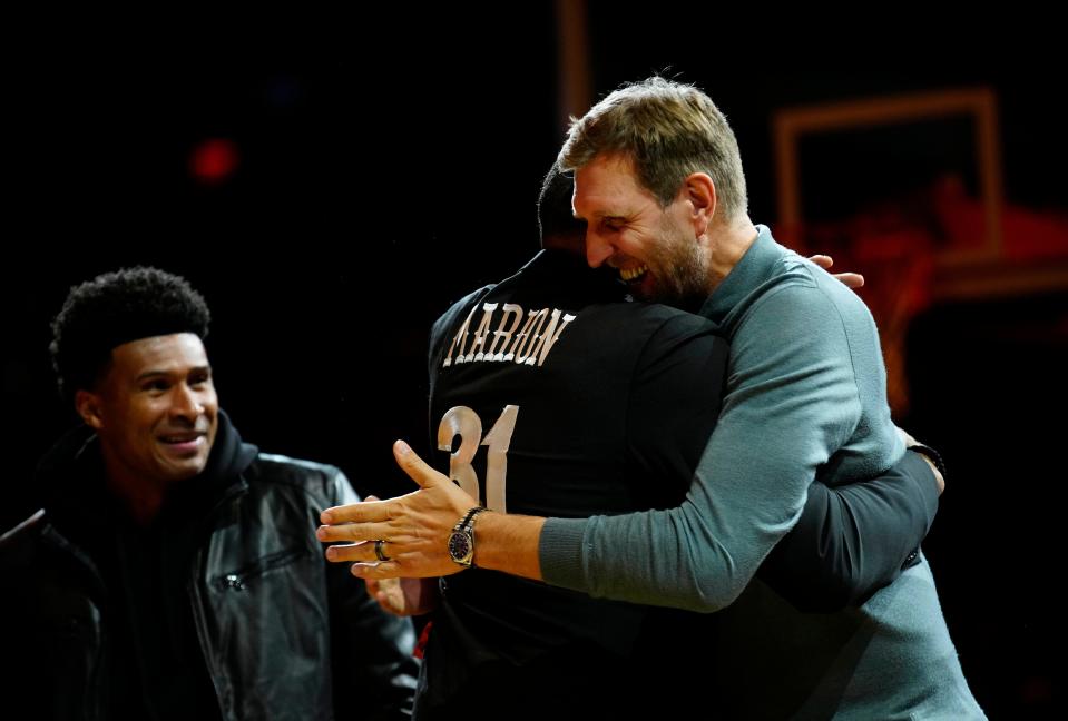Phoenix Suns legend Shawn Marion and Dallas Mavericks legend Dirk Nowitzki embrace after Marion is inducted into the team's Ring on Honor on Dec. 15, 2023.