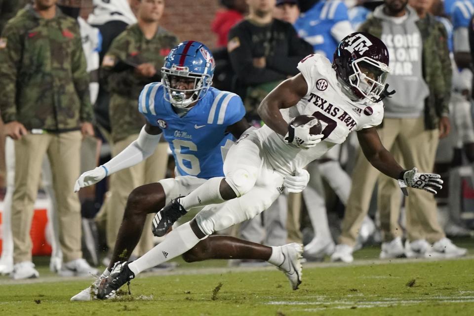 Texas A&M wide receiver Ainias Smith lunges forward with a pass reception in front of Mississippi defensive back Miles Battle (6) Nov. 13, 2021, in Oxford, Miss. Battle transferred to Utah in the offseason. | Rogelio V. Solis, Associated Press