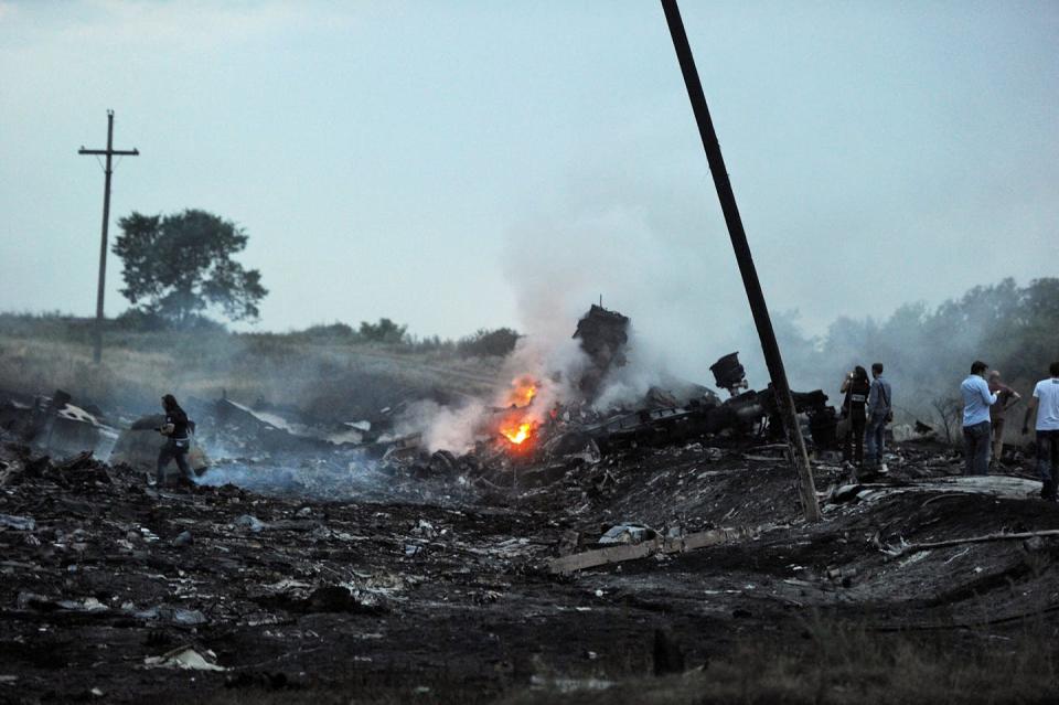 Russian President Vladimir Putin called the downing of Malaysia Airlines Flight 17 over Ukraine in 2014 a ‘tragedy,’ though it was shot down by a Russian missile. <a href="https://www.gettyimages.com/detail/news-photo/people-stand-on-july-17-amongst-the-wreckages-of-the-news-photo/452285540" rel="nofollow noopener" target="_blank" data-ylk="slk:Dominique Faget/AFP via Getty Images;elm:context_link;itc:0" class="link ">Dominique Faget/AFP via Getty Images</a>