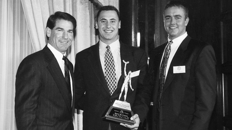 BYU quarterback Steve Sarkisian holds his award after winning the 1996 Sammy Baugh Trophy as the nation's top passer, making him the seventh BYU quarterback to win the honor. It's been more than 25 years since Sarkisian played in Provo, but his name still appears 30 times in this year's BYU football media guide.