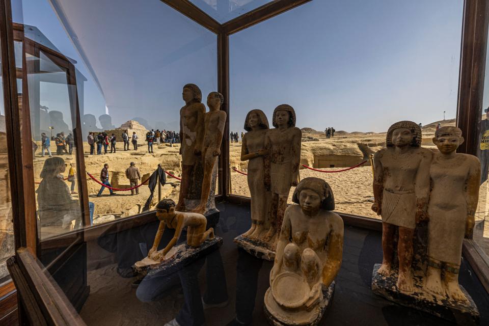 TOPSHOT - A collection of pharaoh statues is on display during a press conference at the Saqqara necropolis, where a gold-laced mummy and four tombs including of an ancient king's 