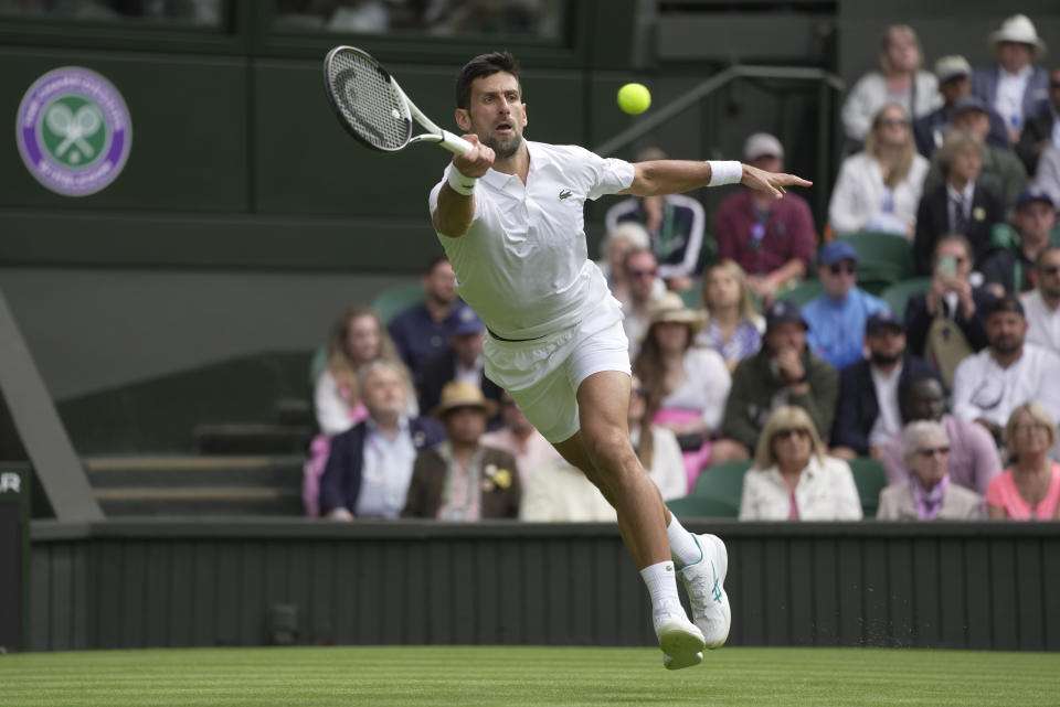 Serbia's Novak Djokovic returns to Argentina's Pedro Cachin during their first round men's singles match on day one of the Wimbledon tennis championships in London, Monday, July 3, 2023. (AP Photo/Kin Cheung)