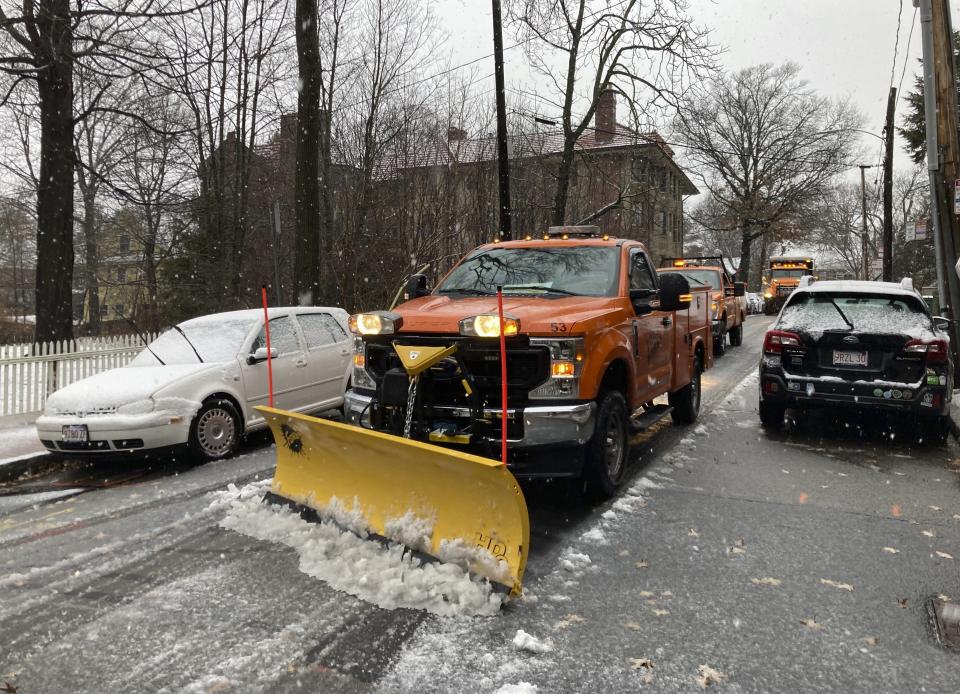 A plow clears snow and slush from sidewalks Sunday, Jan. 7, 2024 in Cambridge, Mass. as a storm bringing a wintry mix of precipitation bears down on the New England region. (AP Photo/Steve LeBlanc)