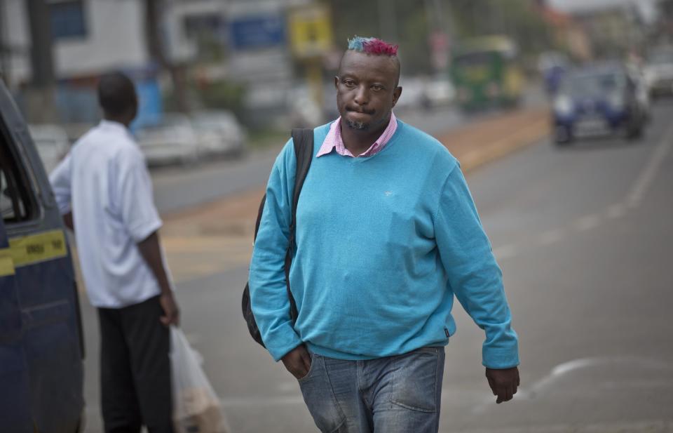 Prize-winning Kenyan author Binyavanga Wainaina walks down a street in Nairobi, Kenya Wednesday, Jan. 22, 2014. Wainaina, one of Africa's leading literary figures, spoke to The Associated Press on Wednesday to explain his decision to publicly declare his homosexuality in an online essay last weekend, in light of a wave of new legislation further criminalizing homosexuality in Nigeria and Uganda. (AP Photo/Ben Curtis)