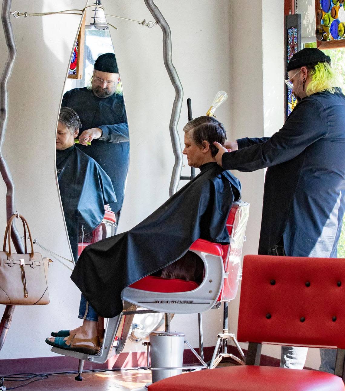 Stylist Richard McDade cuts a client’s hair at Magnolia Ave. Salon in Fort Worth, Texas, on Saturday, Sept. 10, 2022.