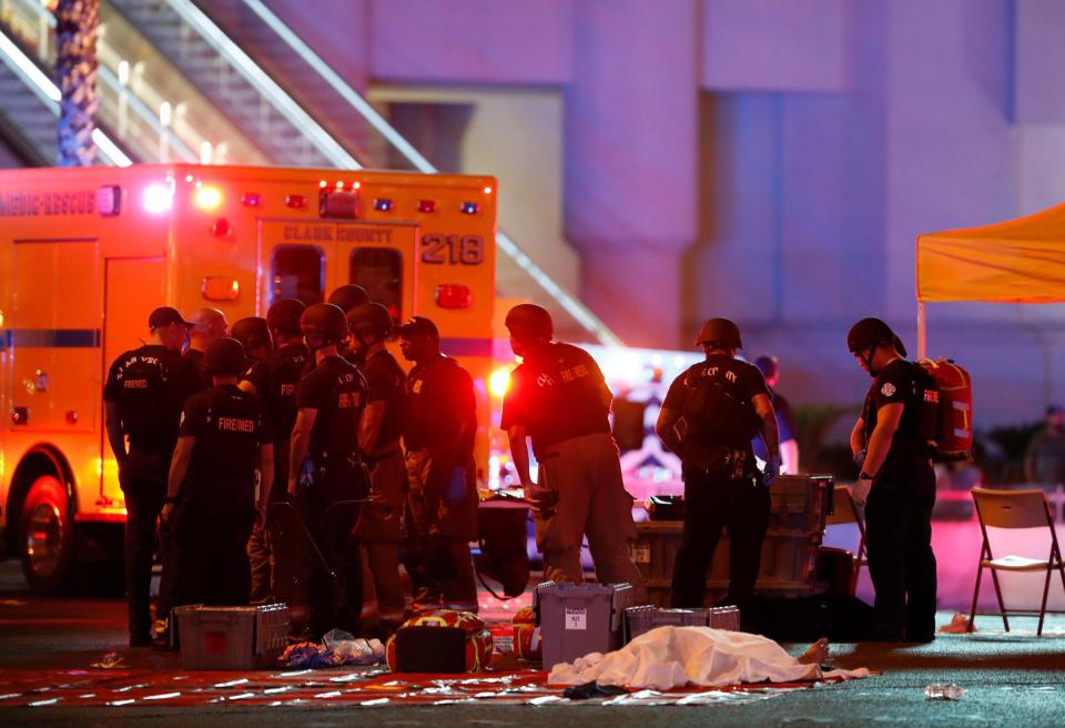 A body is covered with a sheet in the intersection of Tropicana Avenue and Las Vegas Boulevard South after a mass shooting at a music festival on the Las Vegas Strip in Las Vegas