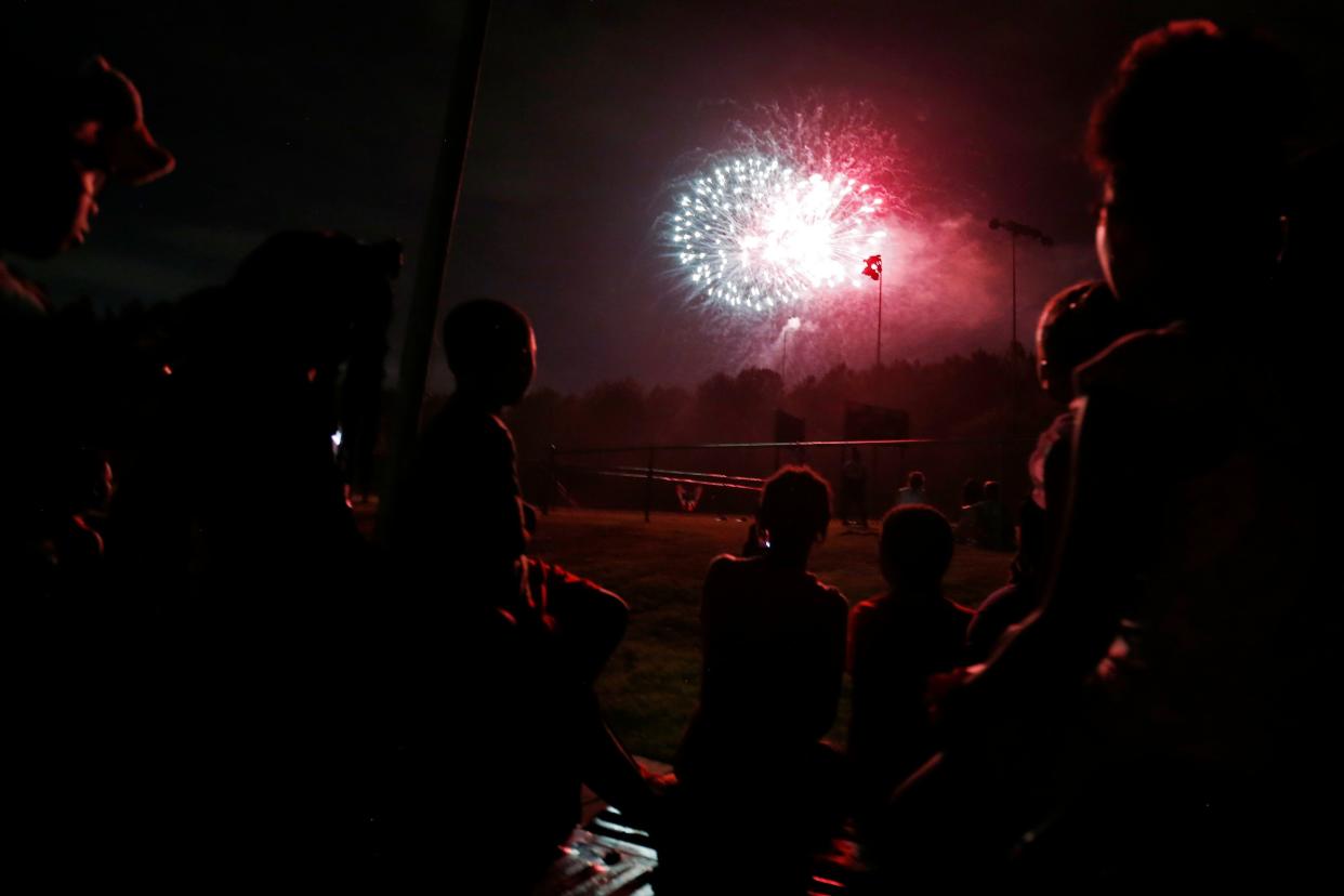 FILE - Locals watch the fireworks during the Athens Star Spangled Classic fireworks in Athens, Ga., on Saturday, July 2, 2022. Fireworks can upset animals due to their sensitive ears. The local animal shelter often sees an uptick in runaways during fireworks displays.