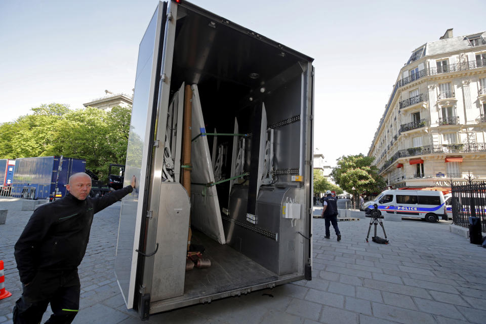 Large artworks are seen in a truck after being removed from Notre-Dame Cathedral to be secured after a massive fire devastated large parts of the gothic cathedral in Paris, Friday, April 19, 2019. Rebuilding Notre Dame, the 800-year-old Paris cathedral devastated by fire this week, will cost billions of dollars as architects, historians and artisans work to preserve the medieval landmark. (Philippe Wojazer/Pool via AP)