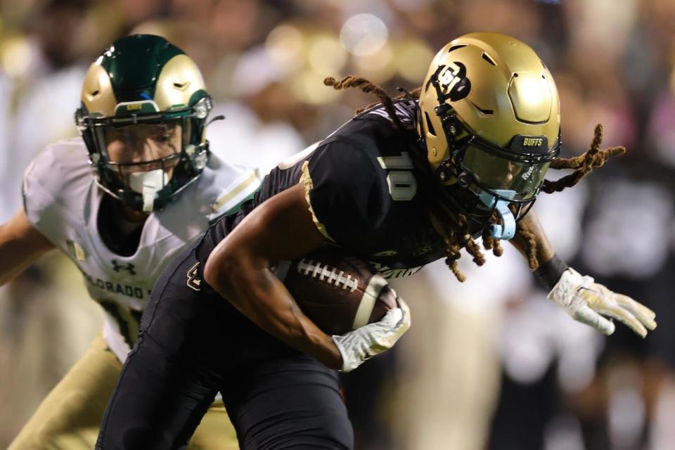 Colorado receiver Xavier Weaver evades a tackle after a catch