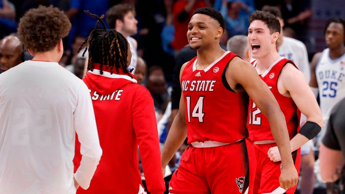 N.C. State’s Casey Morsell (14) and Michael O’Connell (12) celebrate as time runs out in N.C. State’s 74-69 victory over Duke in the quarterfinal round of the 2024 ACC Men’s Basketball Tournament at Capital One Arena in Washington, D.C., Thursday, March 14, 2024.