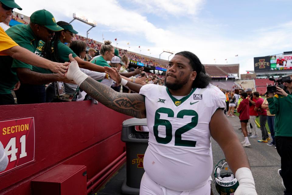 Baylor defensive lineman Siaki Ika (62) celebrates with fans after a 31-24 win at Iowa State on Saturday.