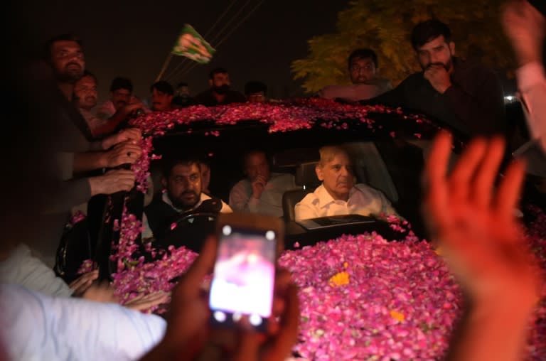 Former Pakistani prime minister Nawaz Sharif was driven away in an SUV as it was pelted with rose petals in celebration, with younger brother Shahbaz Sharif in the front seat of the vehicle