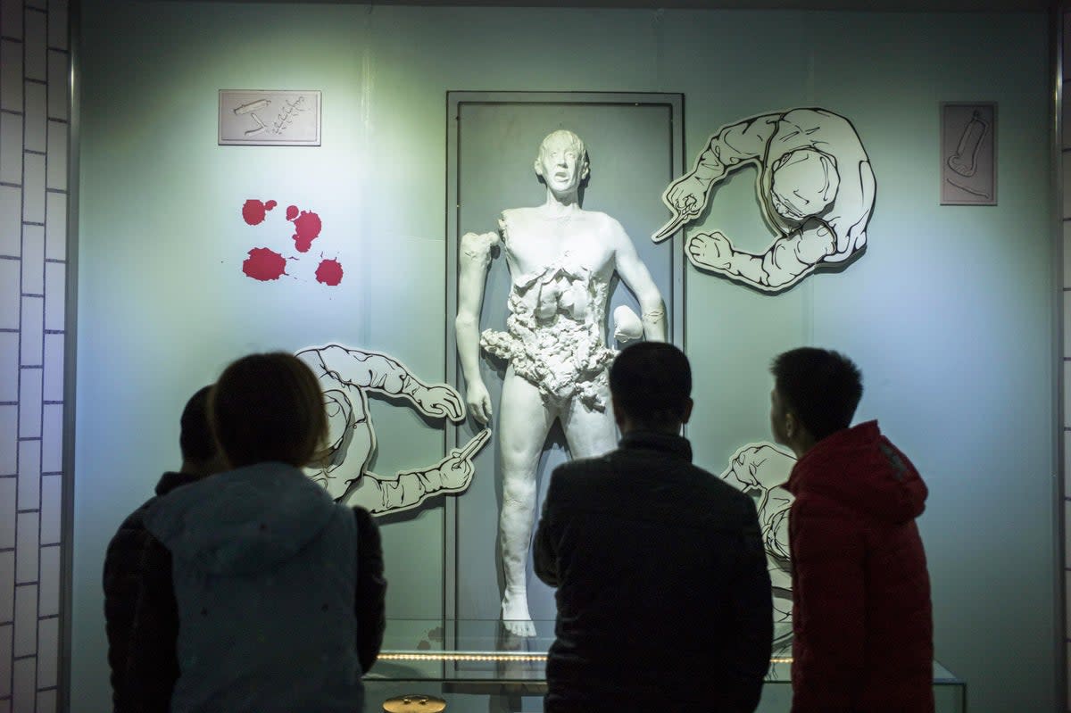 Visitors look at a scene depicting human experiments at the Unit 731 museum in Harbin in northeast China’s Heilongjiang province (AFP via Getty)