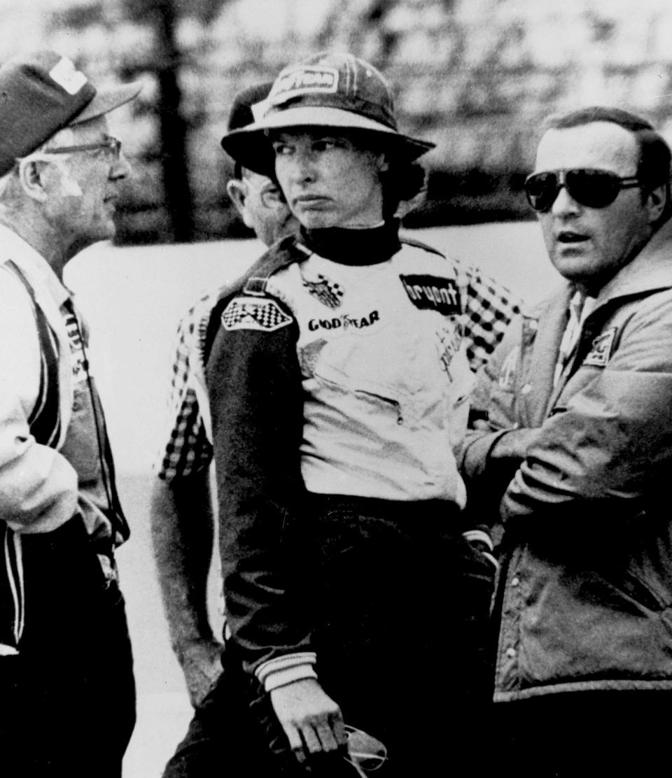 FILE - In this May 23, 1976, file photo, Janet Guthrie talks to racing car owner-builder Rolla Vollstedt, left, and A.J. Foyt, right, in the pits of the Indianapolis Motor Speedway, in Indianapolis. There was no warm reception for Janet Guthrie when she arrived at Indianapolis Motor Speedway 43 years ago. She wanted a spot in the biggest race in the world and her competitors didn't want her anywhere near the Indianapolis 500. (AP Photo/File)