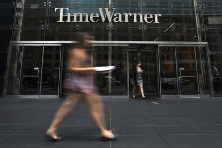 A woman walks past the Time Warner Center near Columbus Circle in Manhattan, New York July 16, 2014. REUTERS/Adrees Latif