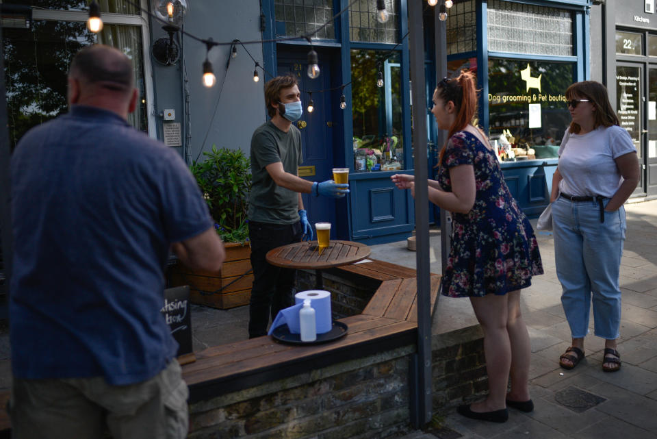 LONDON, ENGLAND - MAY 28: People are seen buying takeaway pints at a pub on Wandsworth Common on May 28 2020 in London, England. The prime minister announced the general contours of a phased exit from the current lockdown, adopted nearly two months ago in an effort curb the spread of Covid-19.  (Photo by Peter Summers/Getty Images)