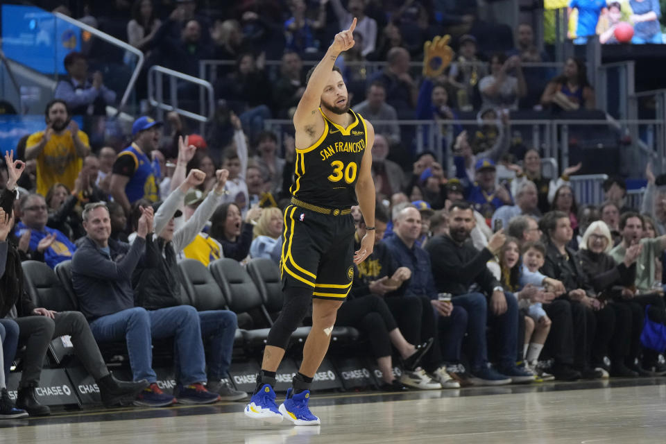 Golden State Warriors guard Stephen Curry gestures after making a 3-point basket against the Portland Trail Blazers during the first half of an NBA basketball game in San Francisco, Saturday, Dec. 23, 2023. (AP Photo/Jeff Chiu)