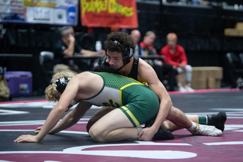 Pueblo East's Justus Freeman, right, works from the top position as Pueblo County's Vincent Sanchez-Vasquez attempts to escape during their Class 4A 157-pound first-round matchup of CHSAA state wrestling tournament on Thursday, February, 15, 2024.
