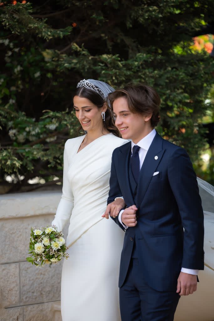 Rajwa Al-Saif walking to the altar with her groom's younger brother, Prince Hashem