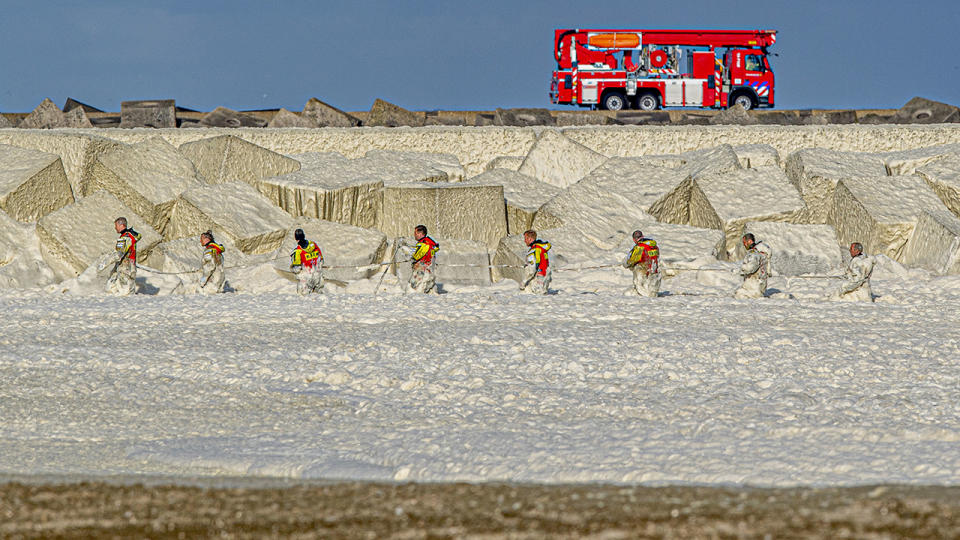 The coastguard, police and fire brigade, pictured here searching for the missing surfers.