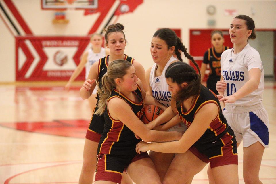 Bishop Chatard junior forward Anna Caskey (center) gets tied up for the ball with McCutcheon sophomore Chloe Finney (left), junior Kalea Washington (right) and sophomore Aubrey Miller (back) during the Twin Lakes Holiday Tournament title game on Dec. 28, 2023.