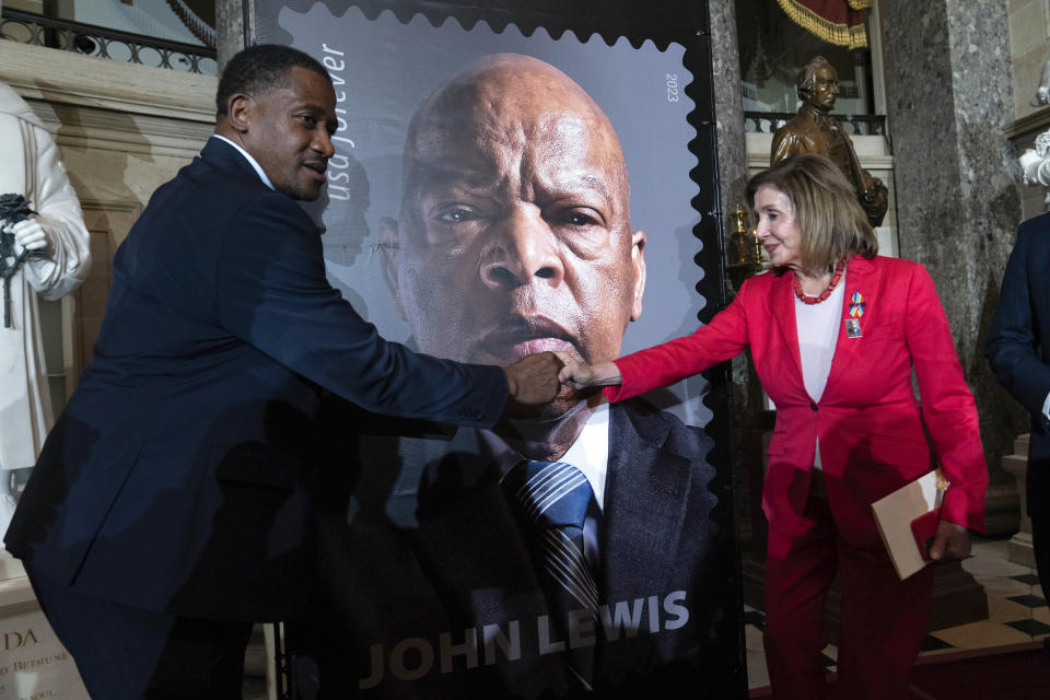 Rep. Nancy Pelosi D-Calif., shake hands with Michael Collins during the stamp unveiling ceremony for Rep. John Lewis on Capitol Hill, Wednesday, June 21, 2023, in Washington. (AP Photo/Jose Luis Magana)