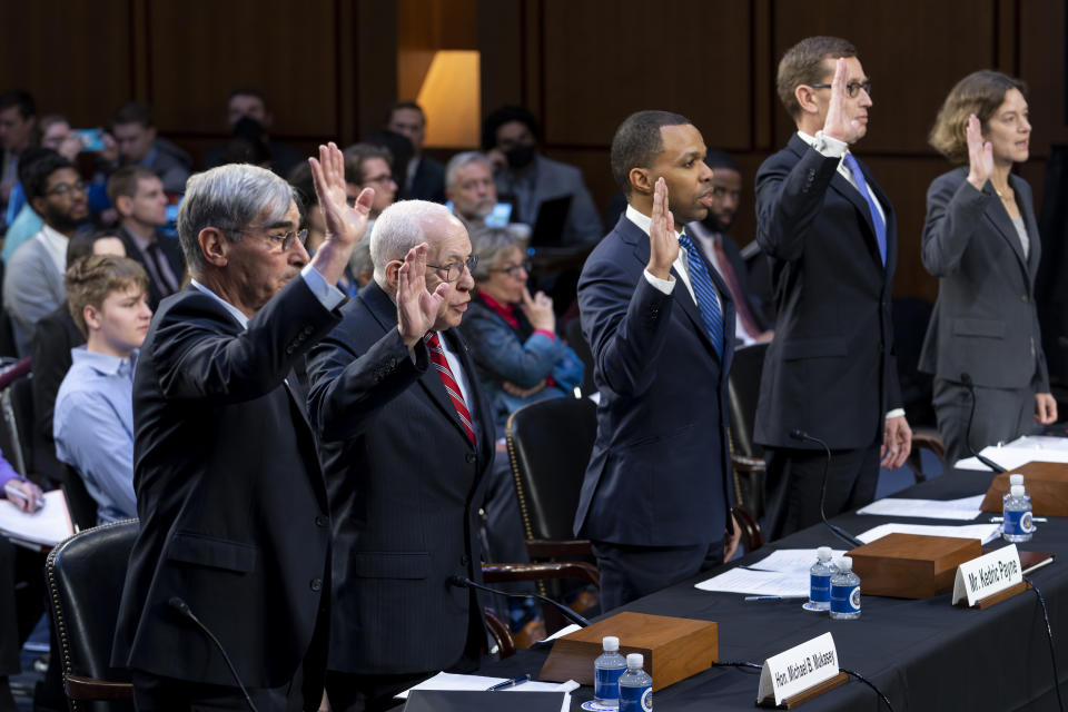 A panel of witnesses, including former Attorney General Michael Mukasey, second from left, are sworn in as the Senate Judiciary Committee holds a hearing in response to recent criticism of the ethical practices of some justices of the Supreme Court, at the Capitol in Washington, Tuesday, May 2, 2023. Associate Justice Clarence Thomas has been criticized for accepting luxury trips nearly every year for more than two decades from Republican megadonor Harlan Crow without reporting them on financial disclosure forms. (AP Photo/J. Scott Applewhite)