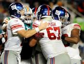 Dec 14, 2015; Miami Gardens, FL, USA; New York Giants quarterback Eli Manning (left) tries to break up a fight involving teammate Justin Pugh at Sun Life Stadium. Mandatory Credit: Robert Duyos-USA TODAY Sports