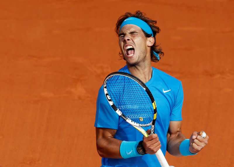 FILE PHOTO: Spain's Rafa Nadal celebrates victory against American John Isner in the French Open first round at Roland Garros in Paris.