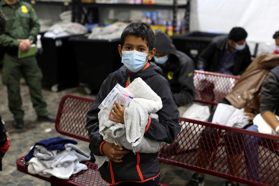 A young migrant boy waits for his turn to take a shower at the Department of Homeland Security holding facility in Donna, Texas on March 30, 2021. (Dario Lopez-Mills/Pool via Reuters) 