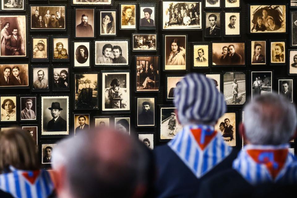 Holocaust survivors stand in 2023 in front of photos that belonged to incoming prisoners at the concentration and extermination camp Auschwitz Birkenau II. <a href="https://www.gettyimages.com/detail/news-photo/holocaust-survivors-are-seen-in-front-of-personal-photos-news-photo/1246610702?adppopup=true" rel="nofollow noopener" target="_blank" data-ylk="slk:Beata Zawrzel/NurPhoto via Getty Images;elm:context_link;itc:0;sec:content-canvas" class="link ">Beata Zawrzel/NurPhoto via Getty Images</a>